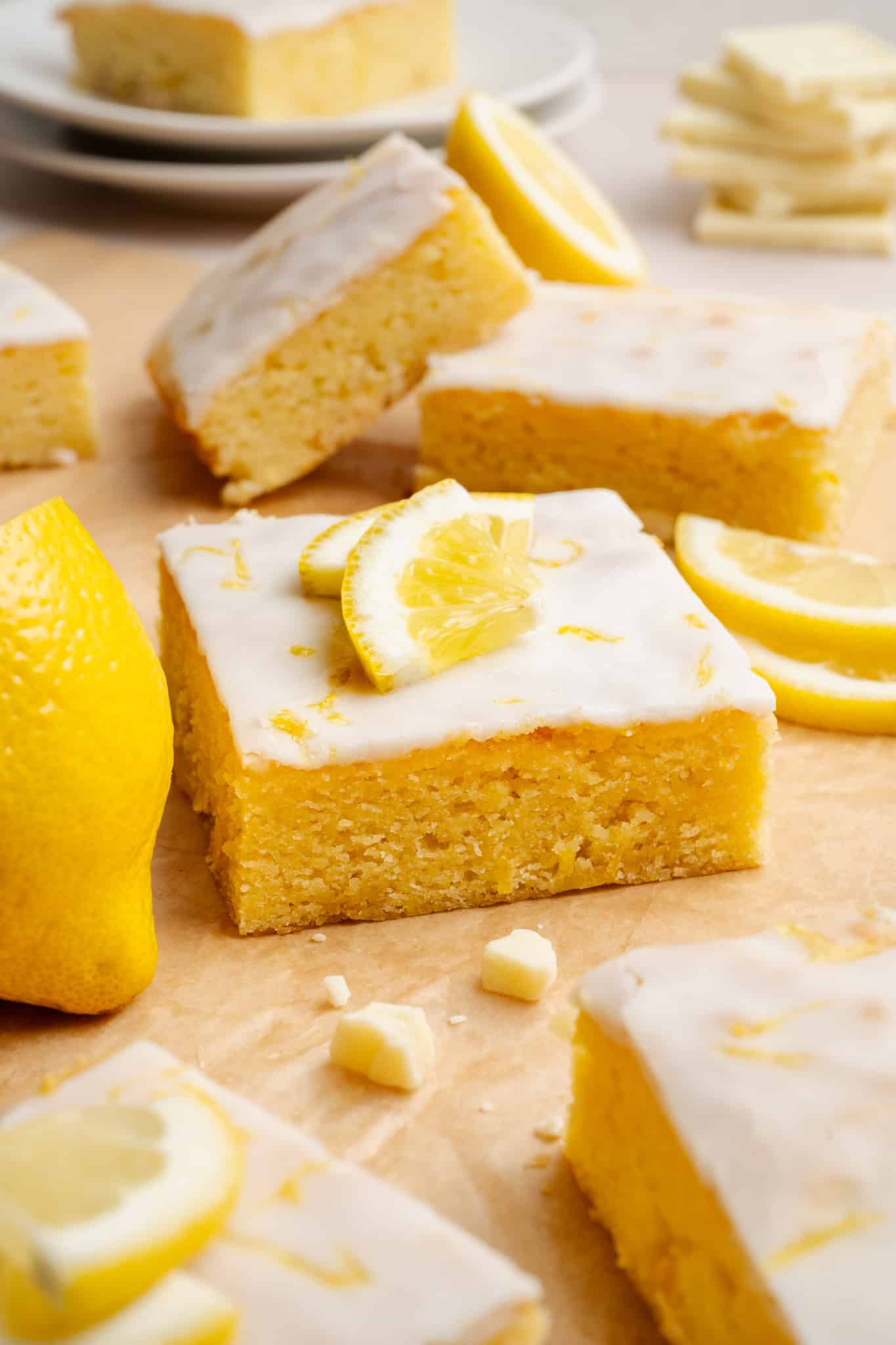Lemon brownie square garnished with lemon wedges and lemon zest.