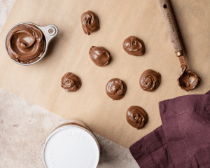 Nutella scooped out onto parchment paper to place in the freeze before adding to cookie dough.