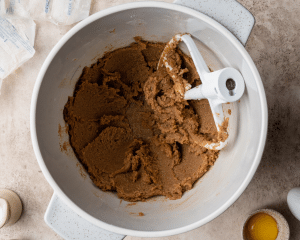 Creaming the butter and sugars together in a bowl.
