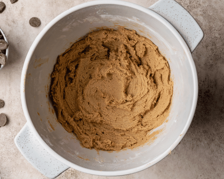 Wet and dry ingredients combined in bowl to make cookie dough.