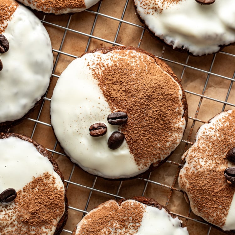 Espresso martini cookie on wire rack garnished with cocoa powder and coffee beans.