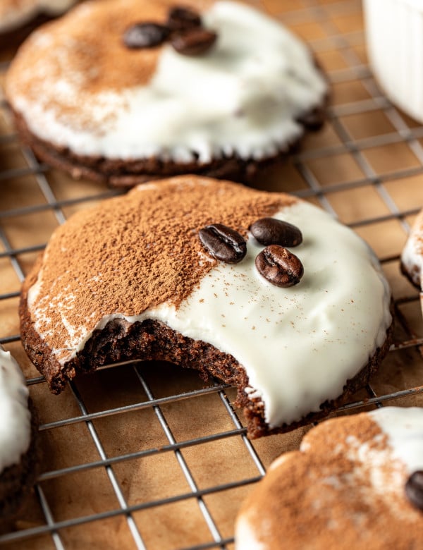 Espresso martini cookie on wire rack with bite taken out of the middle of the cookie.
