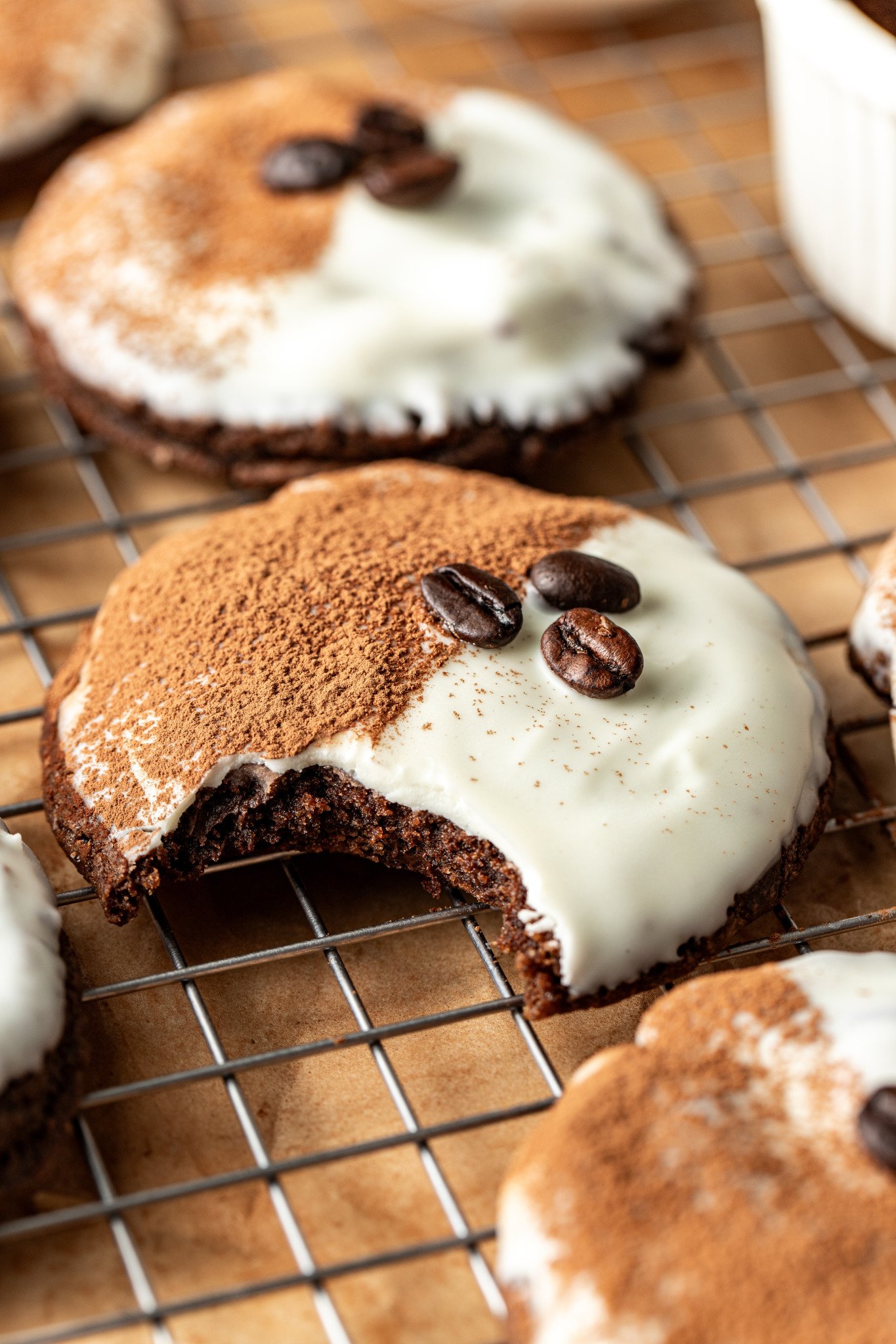 Espresso martini cookie on wire rack with bite taken out of the middle of the cookie.