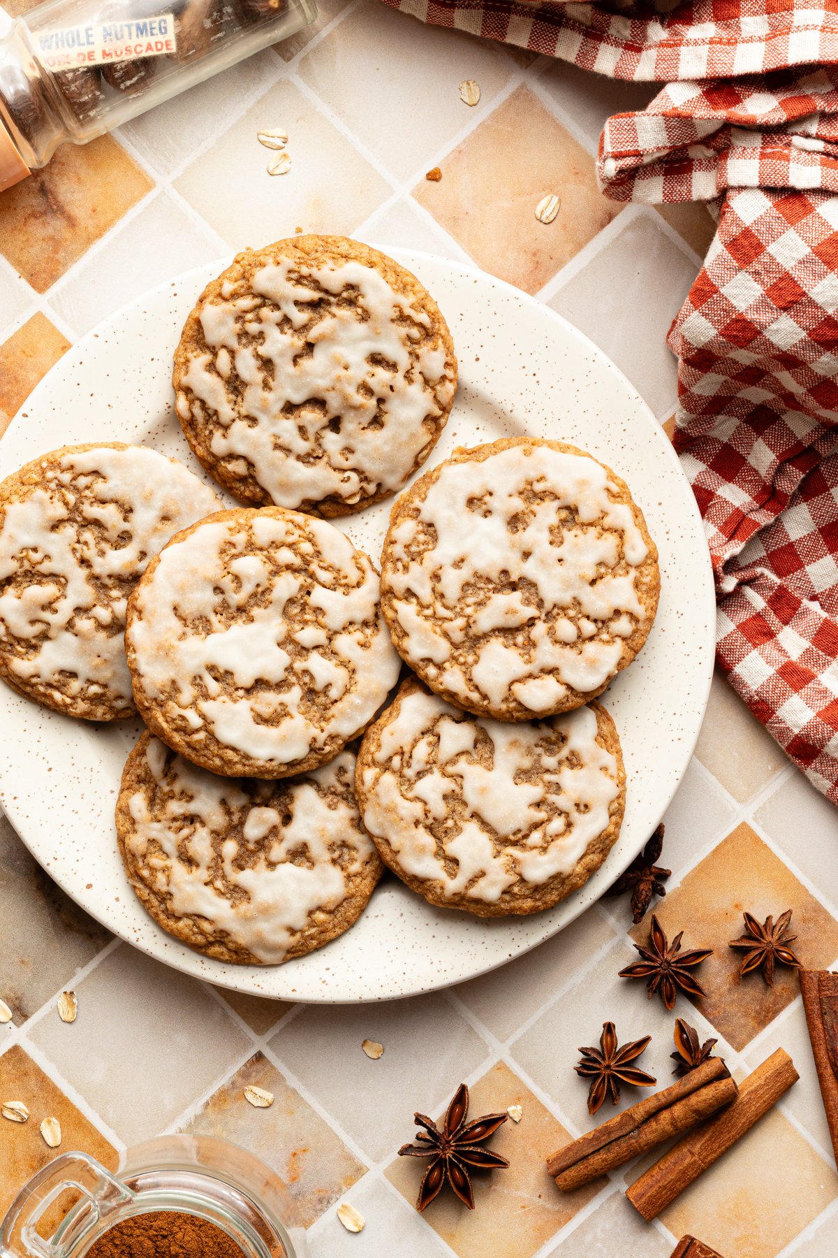 Six iced gingerbread oatmeal cookies on a plate.