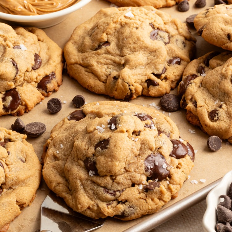 Scooping on peanut butter cookie off a baking tray.