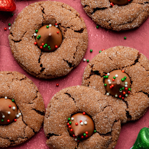 Chocolate peanut butter blossoms on red table.