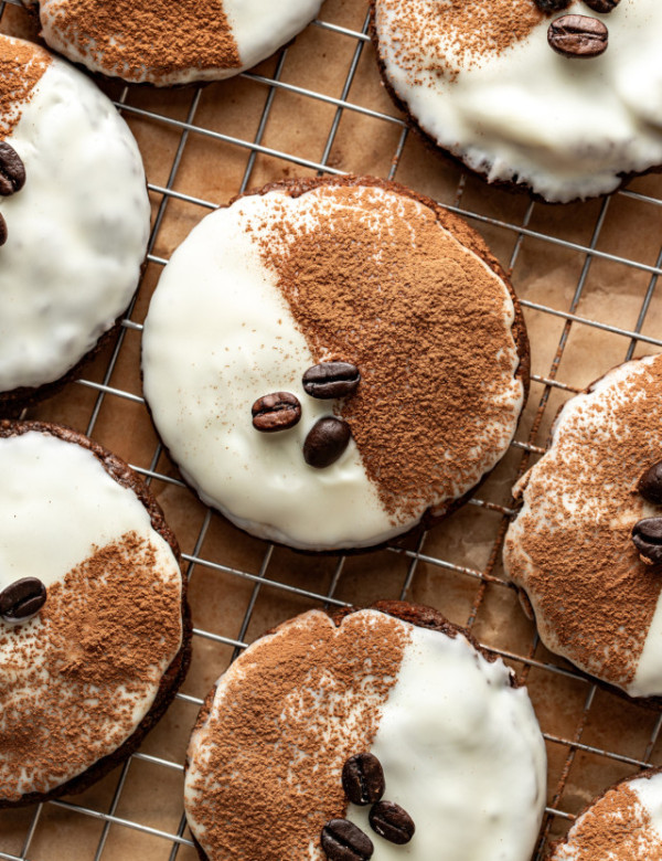 Espresso martini cookie on wire rack garnished with cocoa powder and coffee beans.
