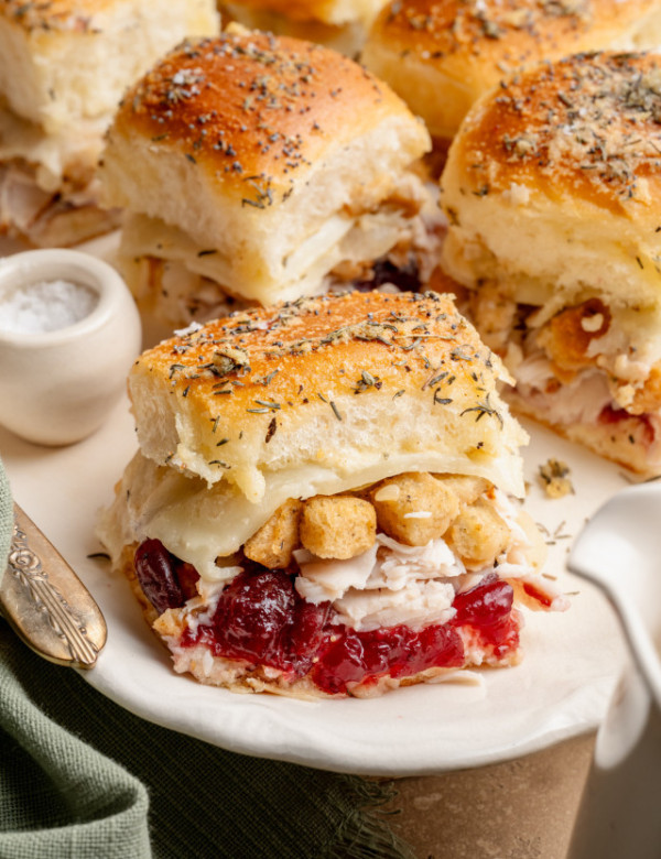 Thanksgiving leftover sliders on white serving dish.