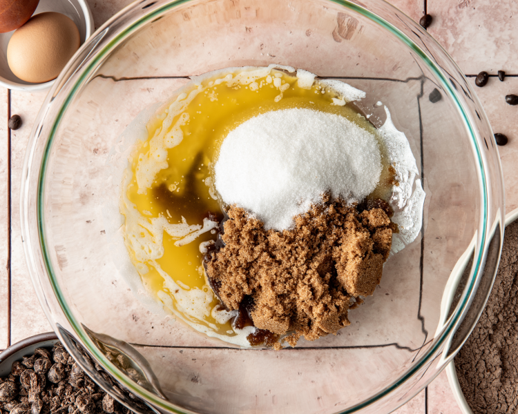 Melted butter and sugars in mixing bowl for espresso cookies.