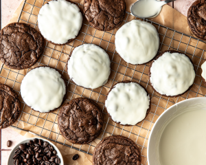 Dipping the cooled espresso martini cookies in white chocolate than placing them on a wire rack to set.