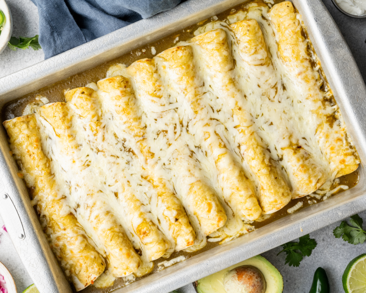 Green chicken enchiladas baked in metal 9x13 pan.