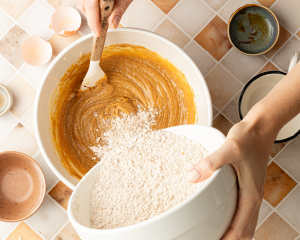 Adding the dry ingredients to the wet mixture.