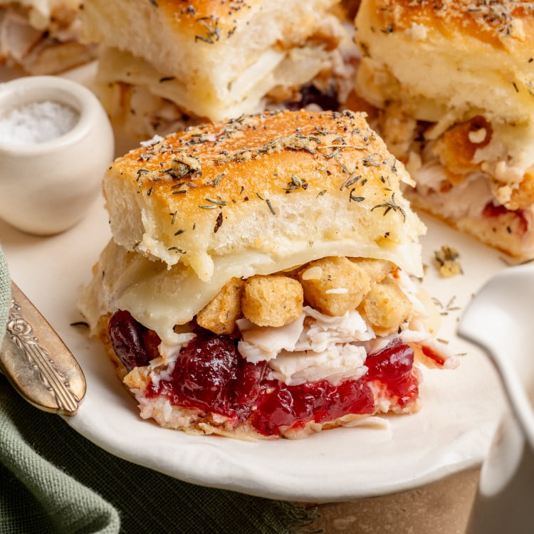 Thanksgiving leftover sliders on white serving dish.