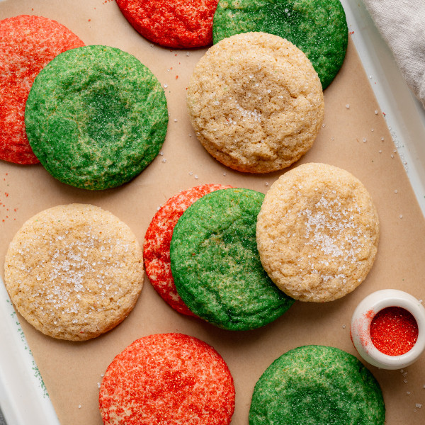 Christmas snickerdoodle cookies on parchment lined baking sheet.