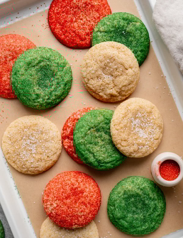 Christmas snickerdoodle cookies on parchment lined baking sheet.