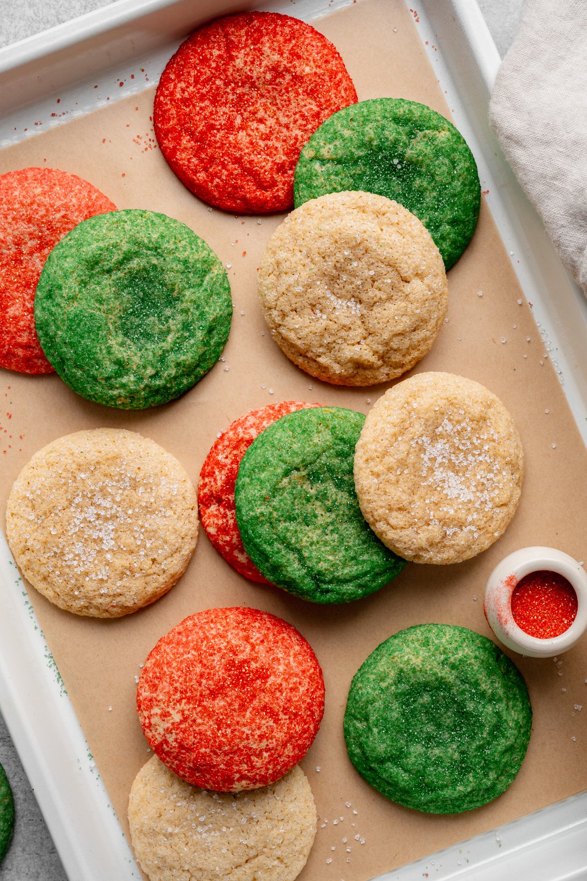 Christmas snickerdoodle cookies on parchment lined baking sheet.