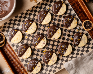 Cranberry orange cookies dipped in chocolate and garnished with orange zest and salt.