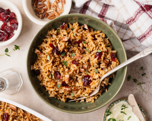 Stick of butter rice in green bowl with fork.
