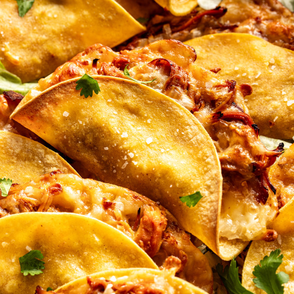 Honey chipotle chicken tacos baked and piled on top on each other.