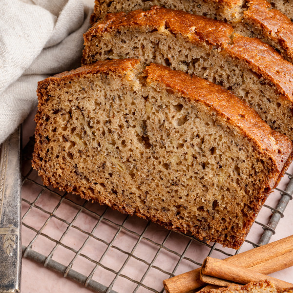 Slices of brown butter banana bread on wire rack.