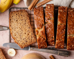 Slices of brown butter banana bread on wire rack.