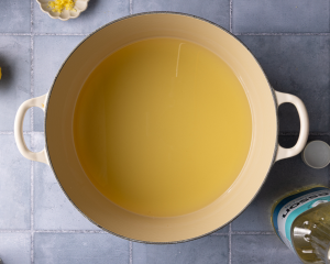 Heating the oil in a large frying pan.
