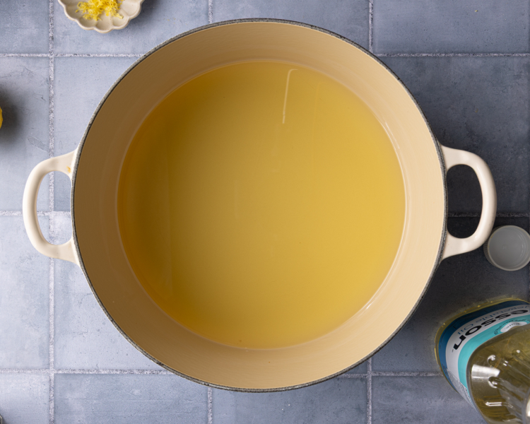 Heating the oil in a large frying pan.