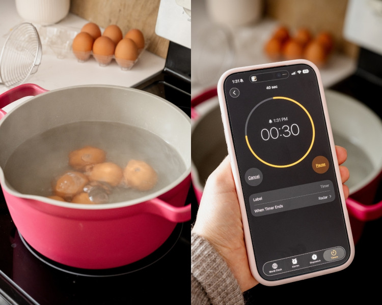 First image shows several eggs simmering in gently boiling water inside a red pot. Second image shows a hand holding a smartphone timer set to 30 seconds while the eggs cook in the background.