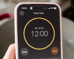 Close-up of a smartphone timer set to 12 minutes for cooking hard boiled eggs.
