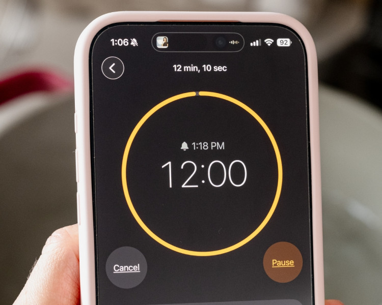 Close-up of a smartphone timer set to 12 minutes for cooking hard boiled eggs.