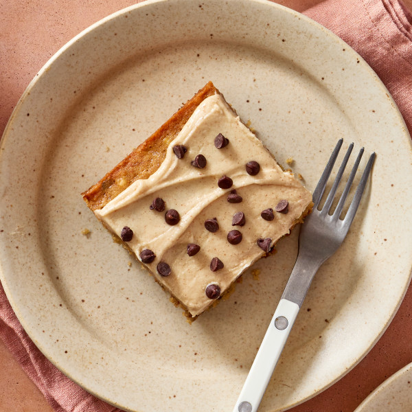 Banana chocolate chip bar cut and placed on plate with a fork.