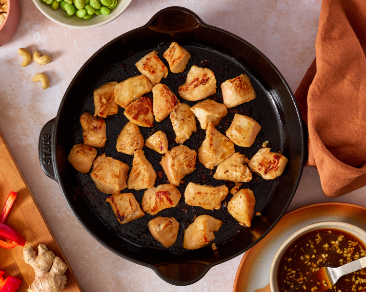 Cooking the chicken in a single layer in the skillet.