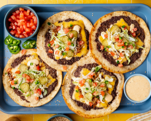 Cheeseburger tacos cooked and topped with favorite burger toppings.
