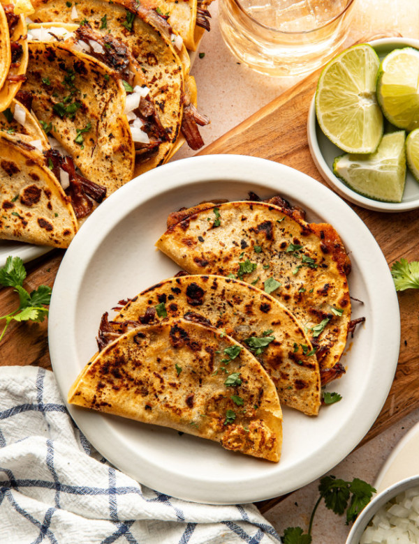 Three birria tacos on plate.