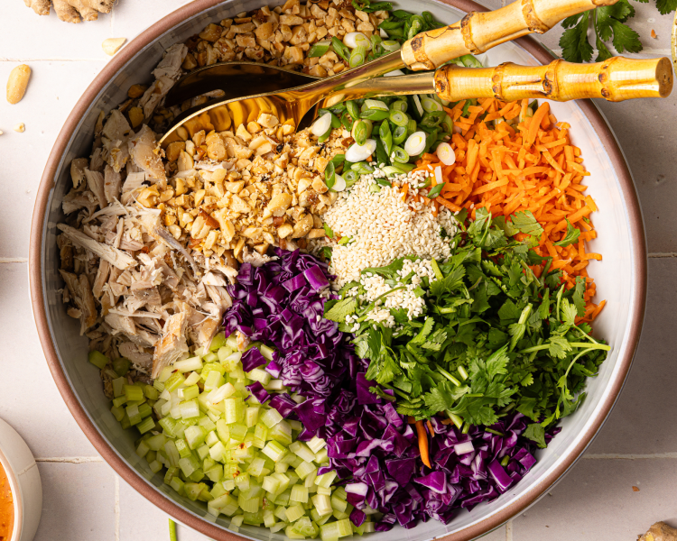 Thai chicken salad ingredients chopped and added to large salad bowl.