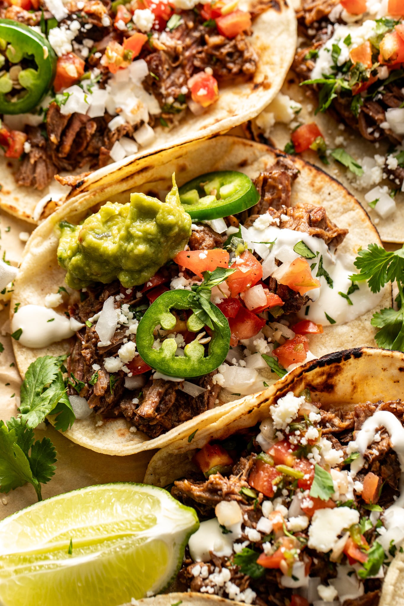 Beef barbacoa taco topping with fresh taco toppings.