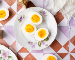 Three egg halves on a plate after cooking.