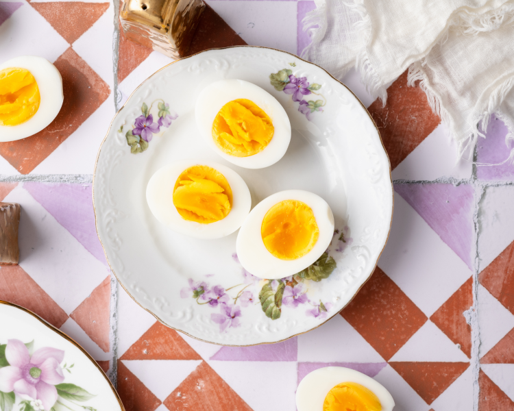 Three egg halves on a plate after cooking.