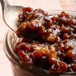 Spoon digging into jar of bacon jam.