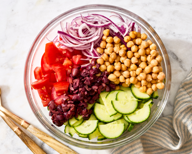 Ingredients prepped and placed in large mixing bowl for cucumber tomato salad.