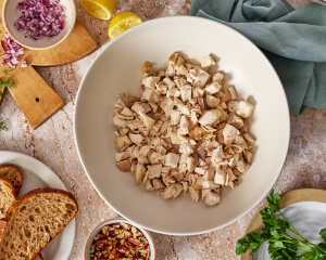 Chopped chicken in mixing bowl for every day chicken salad.