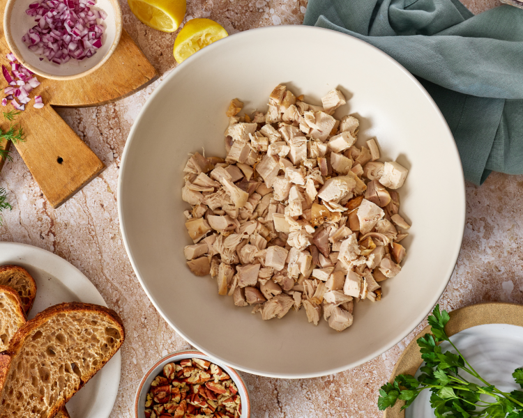 Chopped chicken in mixing bowl for every day chicken salad.