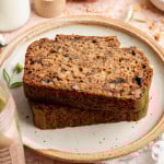 Two slices of healthy banana bread stacked on top of each other and served on a small plate.