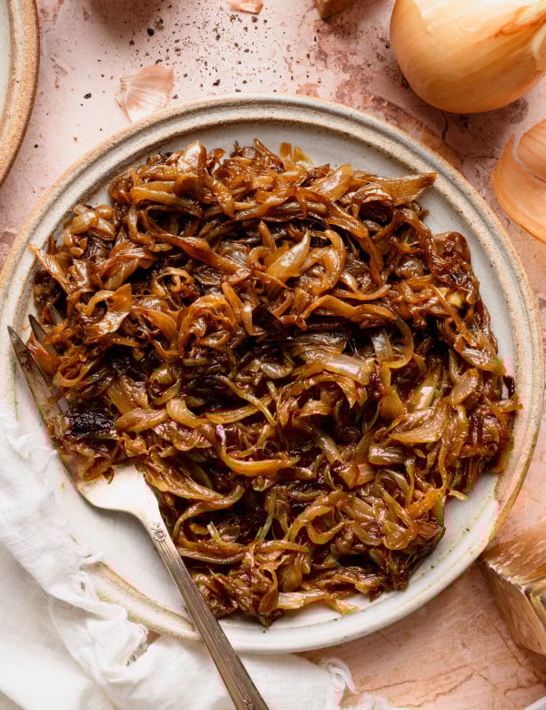 Caramelized onions on a plate with a fork.