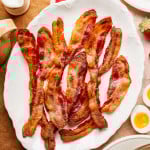 Bacon cooked and served on white plate.
