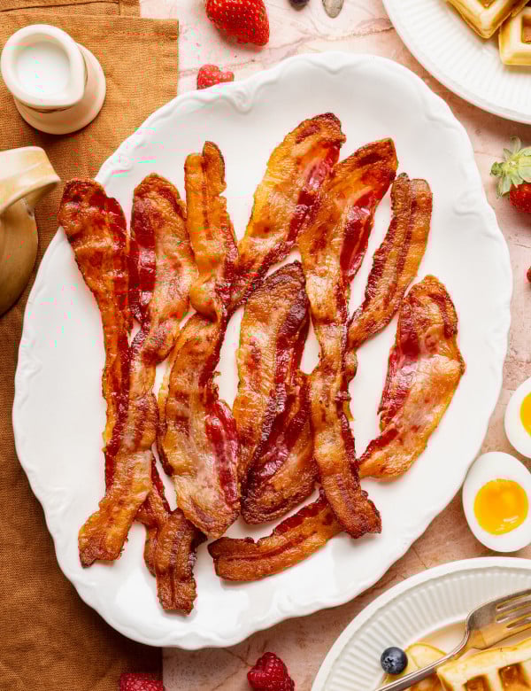 Bacon cooked and served on white plate.