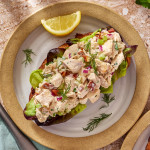Chicken salad served on top piece of bread.