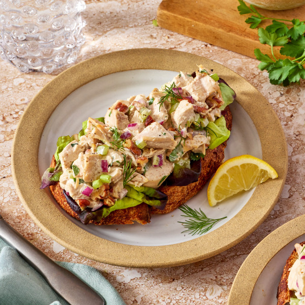 Everyday chicken salad recipe served on top of toast on a small plate.