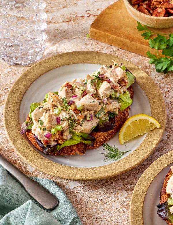 Everyday chicken salad recipe served on top of toast on a small plate.