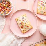 Homemade strawberry pop tart on a pink plate.